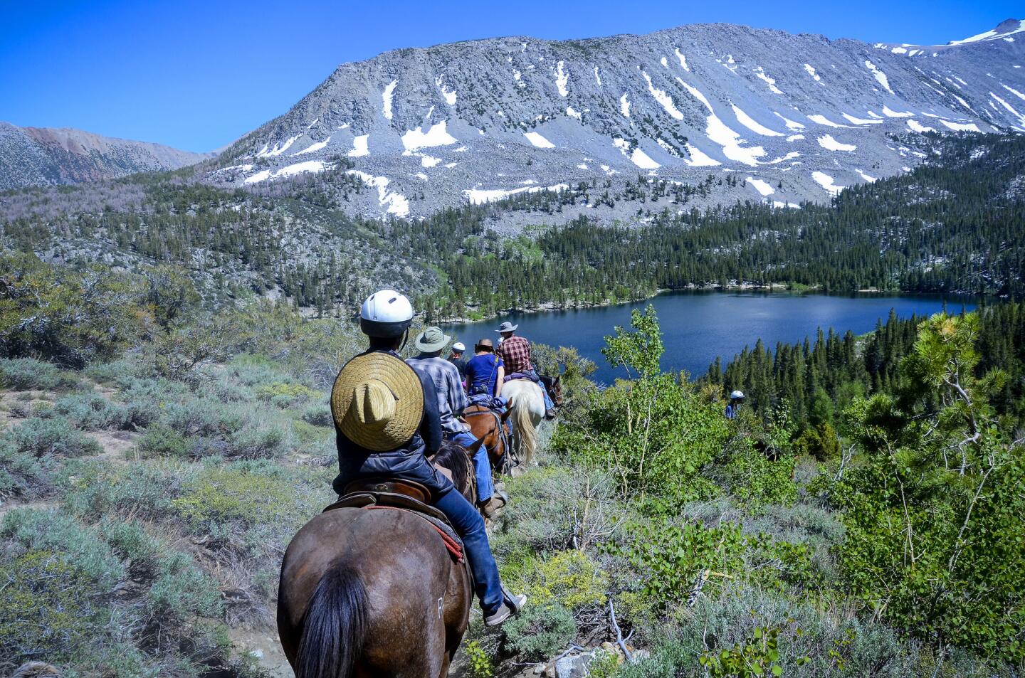 Guests and packers from Rock Creek Pack Station start their ride back to the station from Davis Lake.