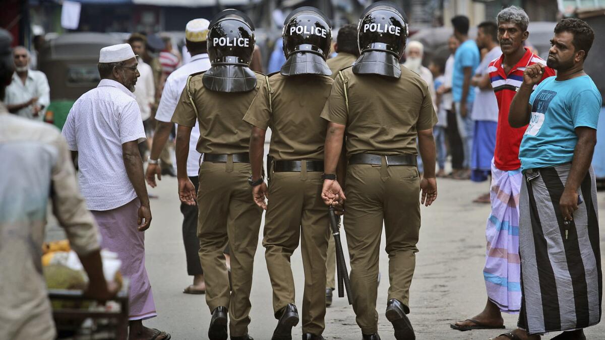 Sri Lanka police patrol a Muslim neighborhood before Friday prayers in Colombo.