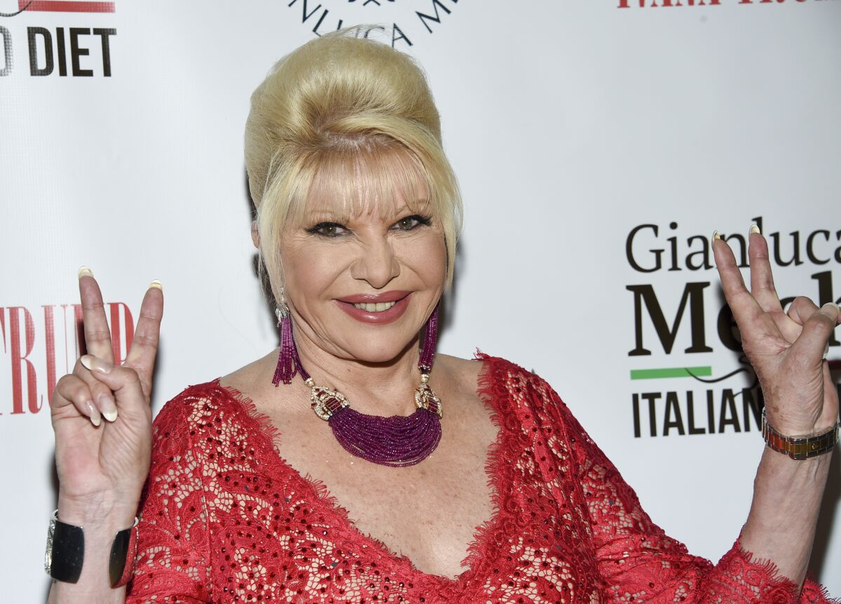 Ivana Trump wearing a red dress and posing for pictures.