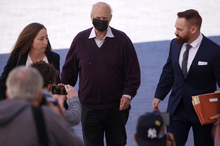 LOS ANGELES, CALIF. - FEB. 6, 2023. Tom Girardi, center, arrives for an initial court appearance at the Edward Roybal Federal Court Building in Los Angeles on Monday, Feb. 6, 2023, after being indicted by a federal grand jury for allegedly embezzling more than $15 million from several of his legal clients. (Luis Sinco / Los Angeles Times)