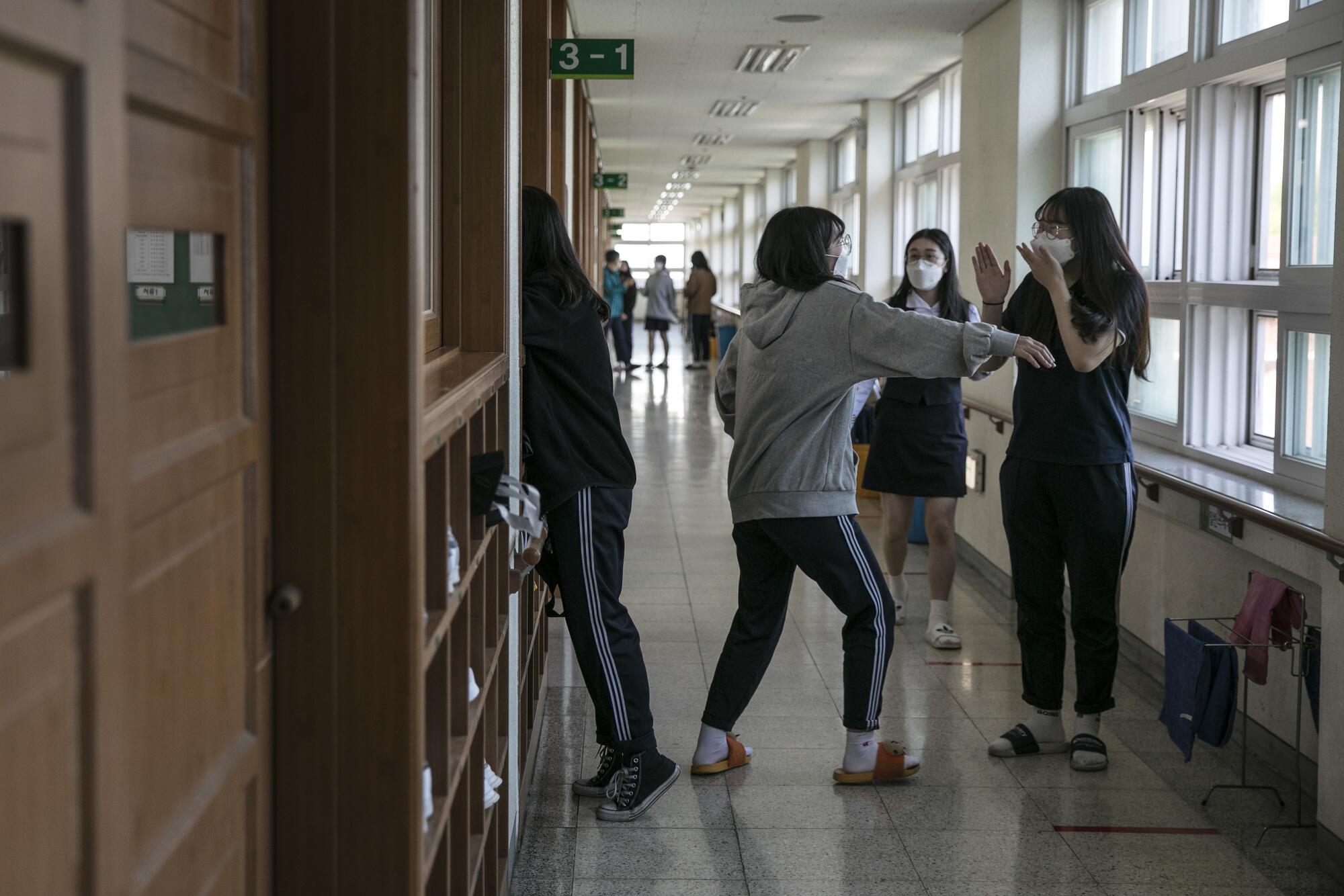 Students at Gyungbuk Girls' High School chat during a break on their first day back in school in Daegu, the city that was at the center of South Korea's coronavirus outbreak.