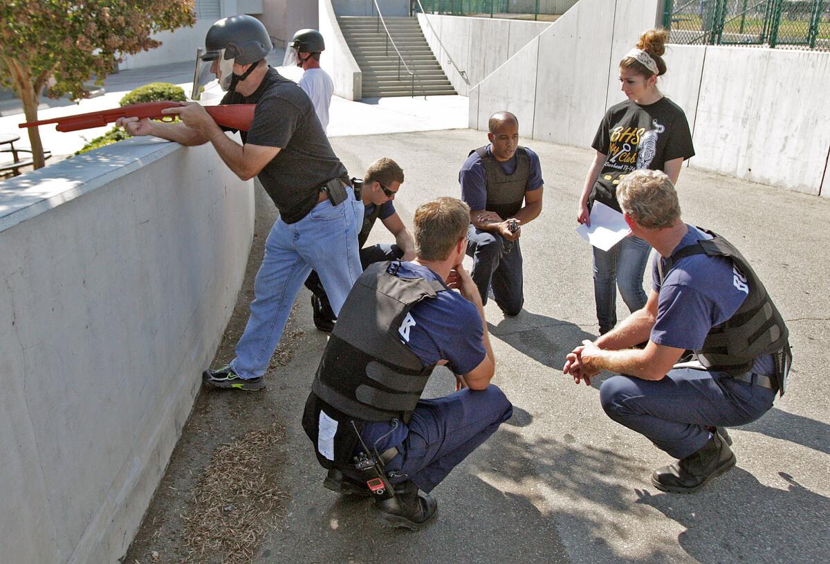 A 'safe location' is found as a shooting drill scenario concludes at Burbank High School as the Burbank Police and Fire Departments work together to run school shooter scenarios to be better prepared to work together to recover the injured for faster treatment on Thursday, August 7, 2014.