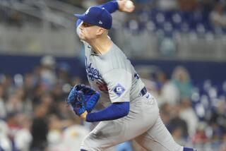 Los Angeles Dodgers pitcher Bobby Miller aims a pitch during the first inning of a baseball game against the Miami Marlins, Tuesday, Sept. 17, 2024, in Miami. (AP Photo/Marta Lavandier)