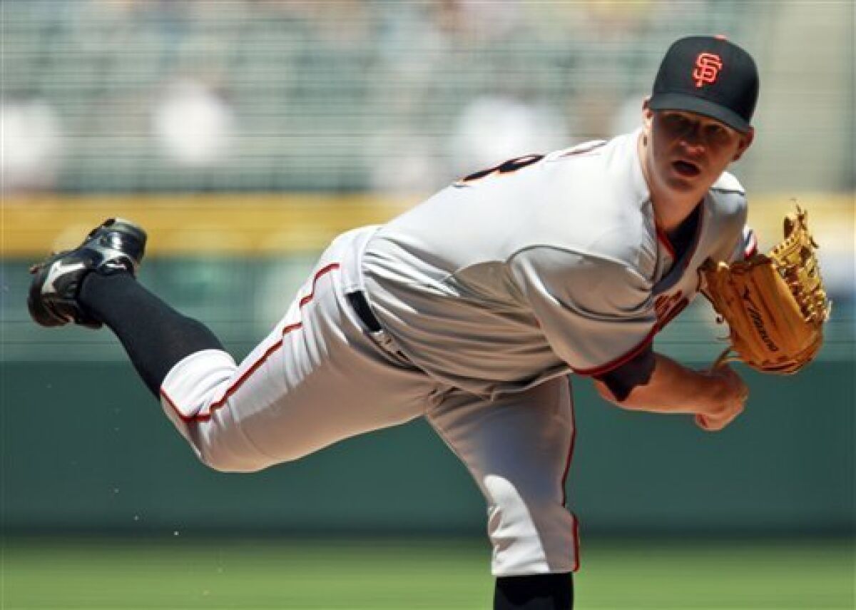 San Francisco Giants starting pitcher Matt Cain works against the Colorado Rockies in the first inning of a baseball game in Denver, on Thursday, May 7, 2009. (AP Photo/David Zalubowski)