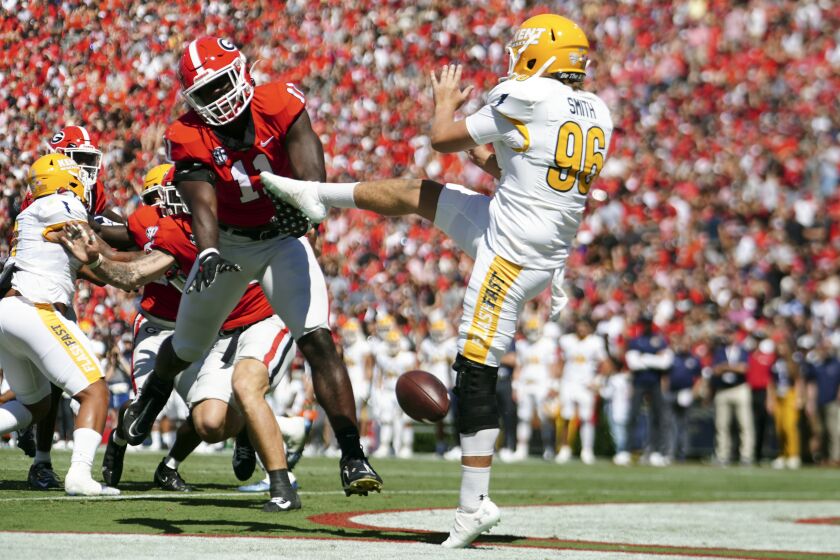 Georgia linebacker Jalon Walker (11) blocks Kent State punter Josh Smith's (96) punt in the first half of an NCAA college football game Saturday, Sept. 24, 2022, in Athens, Ga. The ball went out of the end zone for a safety. (AP Photo/ John Bazemore)
