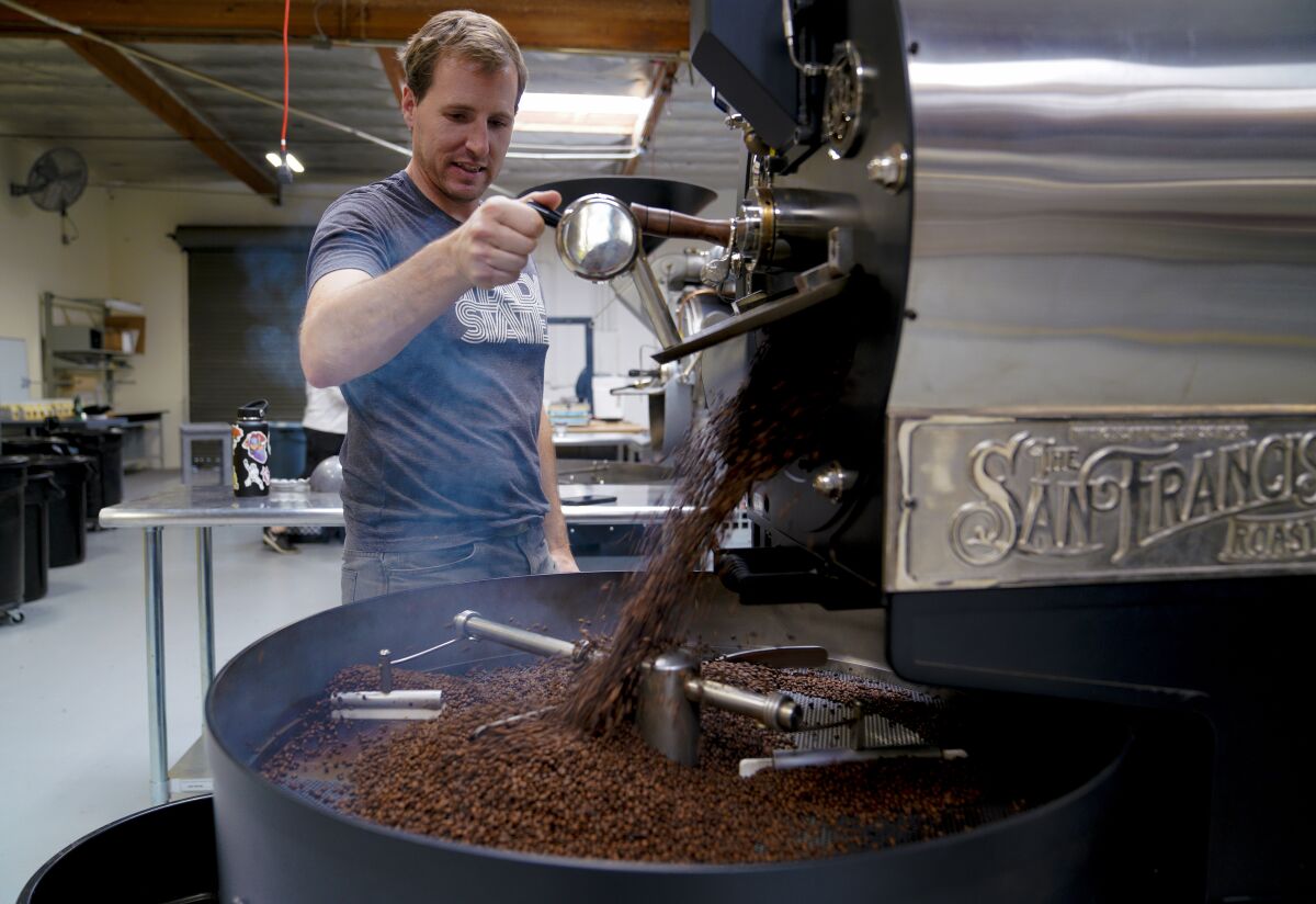 Elliot Reinecke releases the freshly roasted coffee beans that helped Steady State Roasting Co. win the 2020 Good Food Award this week. It's a big validation for company founder Elliot Reinecke of Carlsbad, who started roasting coffee as a hobby in a backyard shed a few years ago.