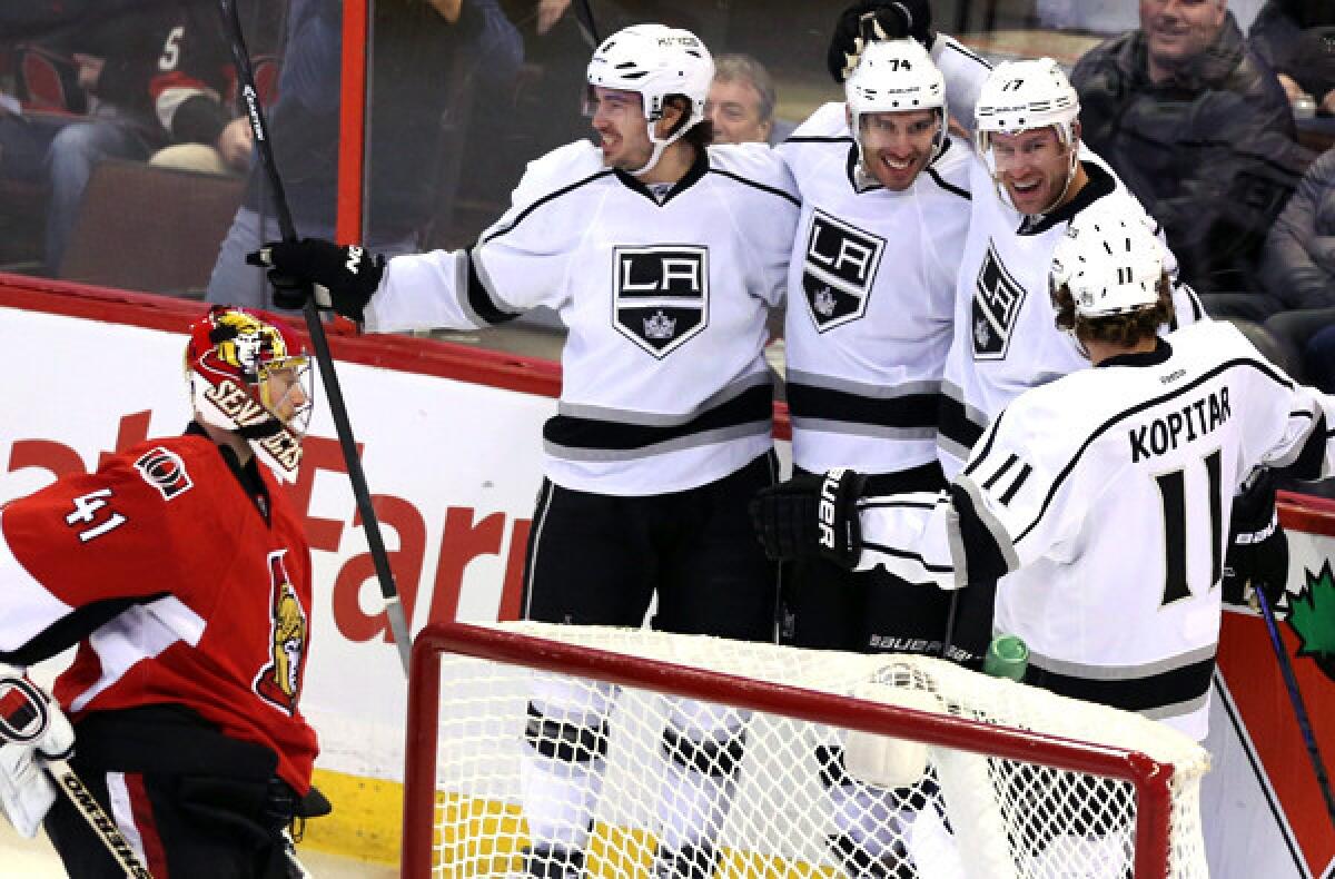 Senators goaltender Craig Anderson can only watch -- and he'd soon be replaced -- as the Kings' Drew Doughty, Dwight King, Jeff Carter and Anze Kopitar celebrate a goal in the first period Saturday in Ottawa.