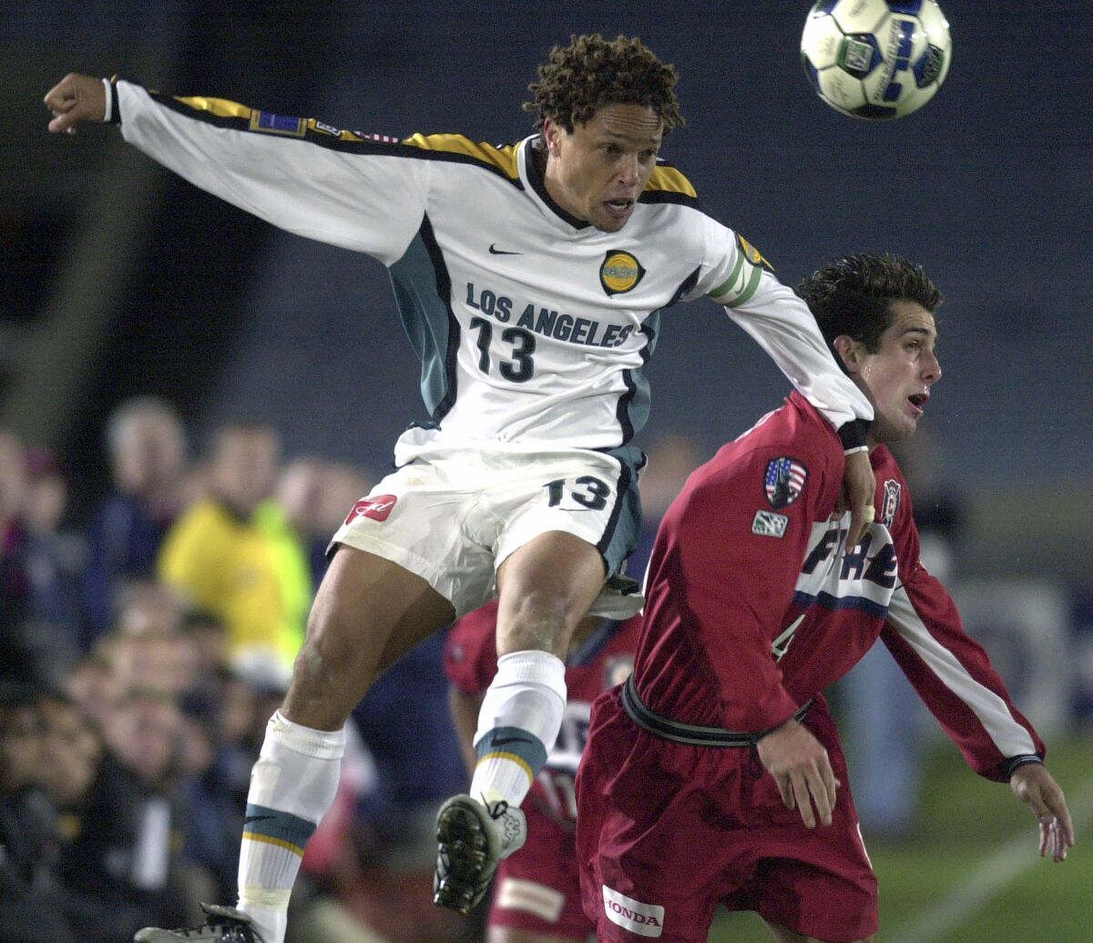 The Galaxy's Cobi Jones (13) heads the ball above the Chicago Fire's Carlos Bocanegra during a 2001 match