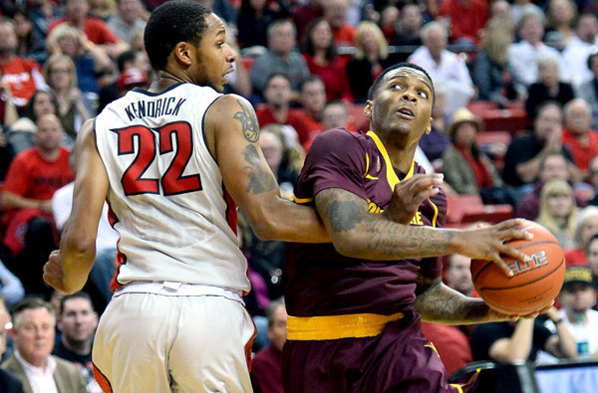 Arizona State point guard Jahii Carson drives to the basketball against UNLV's Jelan Kendrick during a non-conference game earlier this season.