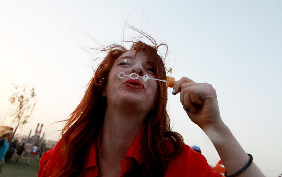 Anna Fryxell, 22, of Los Angeles blows bubbles at the Coachella Valley Music and Arts Festival.