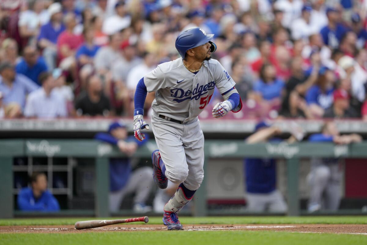 Dodgers' Mookie Betts watches his solo home run against the Cincinnati Reds.