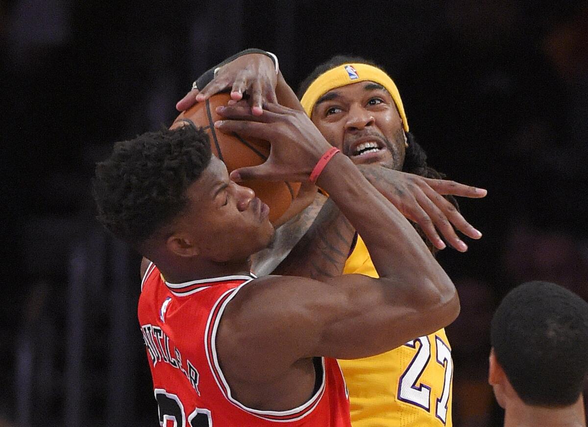 Bulls guard Jimmy Butler battles Lakers center Jordan Hill for possession of the ball in the first half.