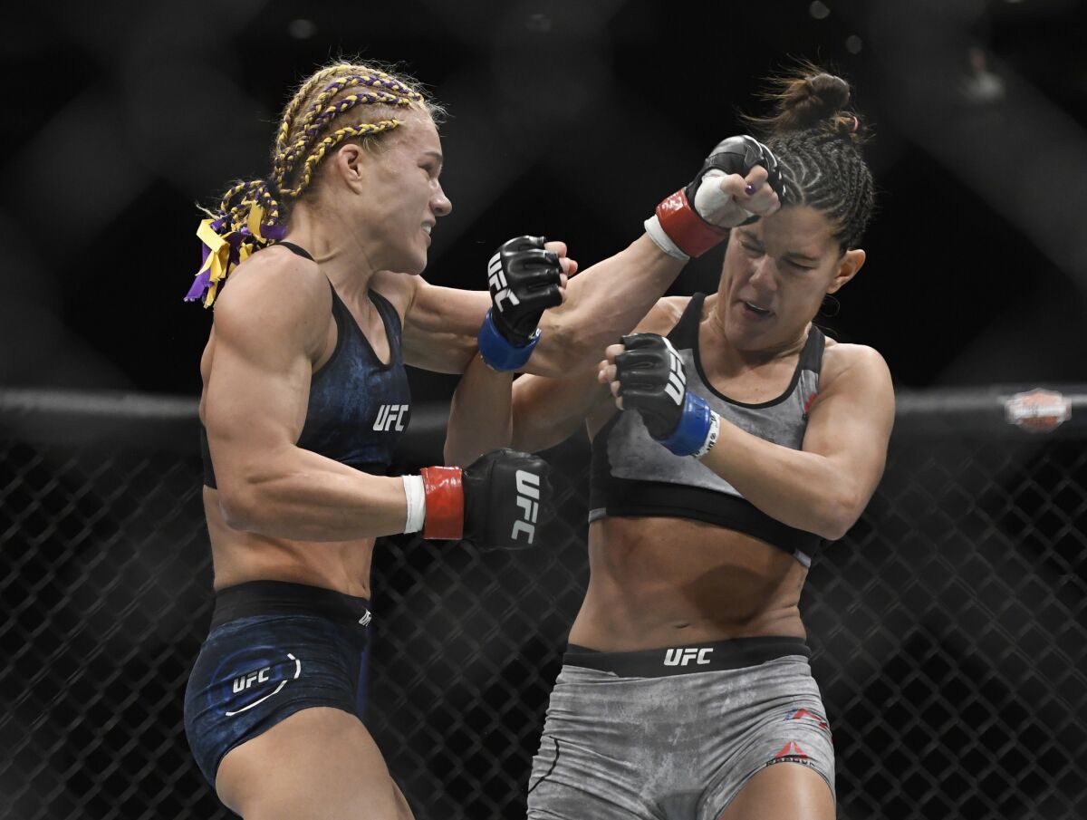 Felice Herrig, left, lands a punch against Cortney Casey during the first round of their strawweight fight at UFC 218.