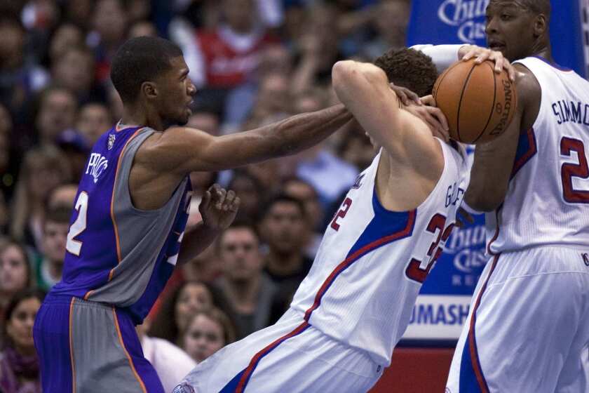 Ronnie Price, while with the Phoenix Suns, tries to strip a rebound from Clippers power forward Blake Griffin.