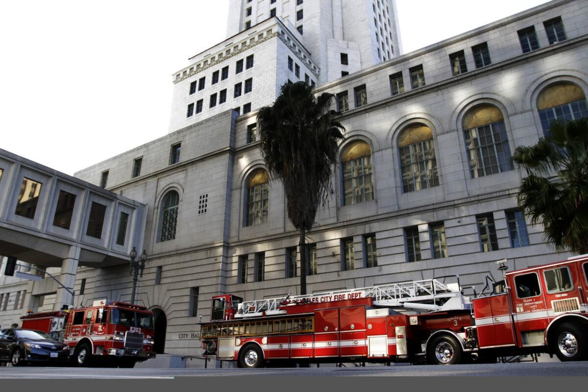 Los Angeles fire units respond to a flood at City Hall last year. Overtime pay climbed for city firefighters in 2013.