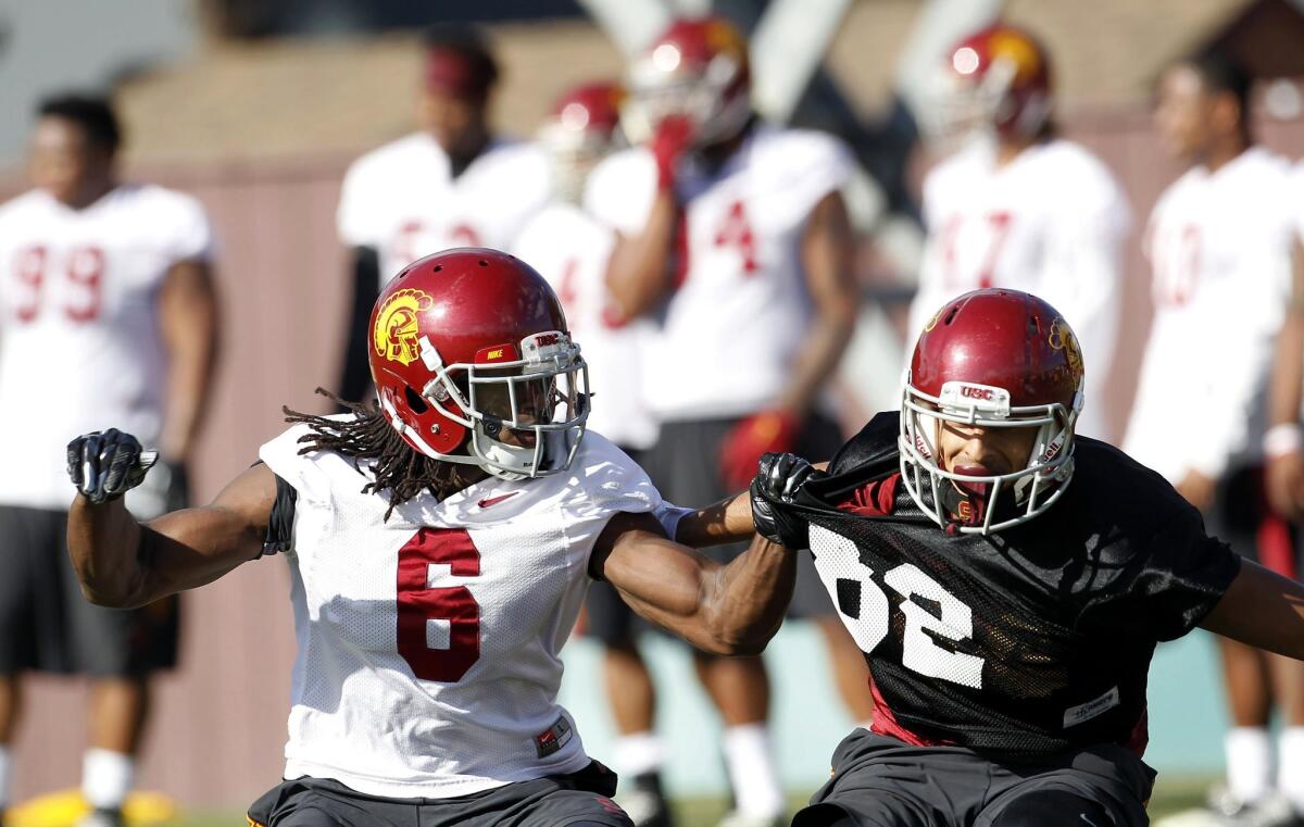 USC cornerback Josh Shaw, left, takes part in his first practice Wednesday after being reinstated to the team this week.