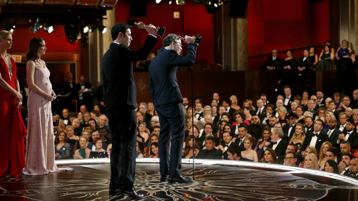 Josh Singer and Tom McCarthy accept the award for Original Screenplay for "Spotlight." (Al Seib / Los Angeles Times)