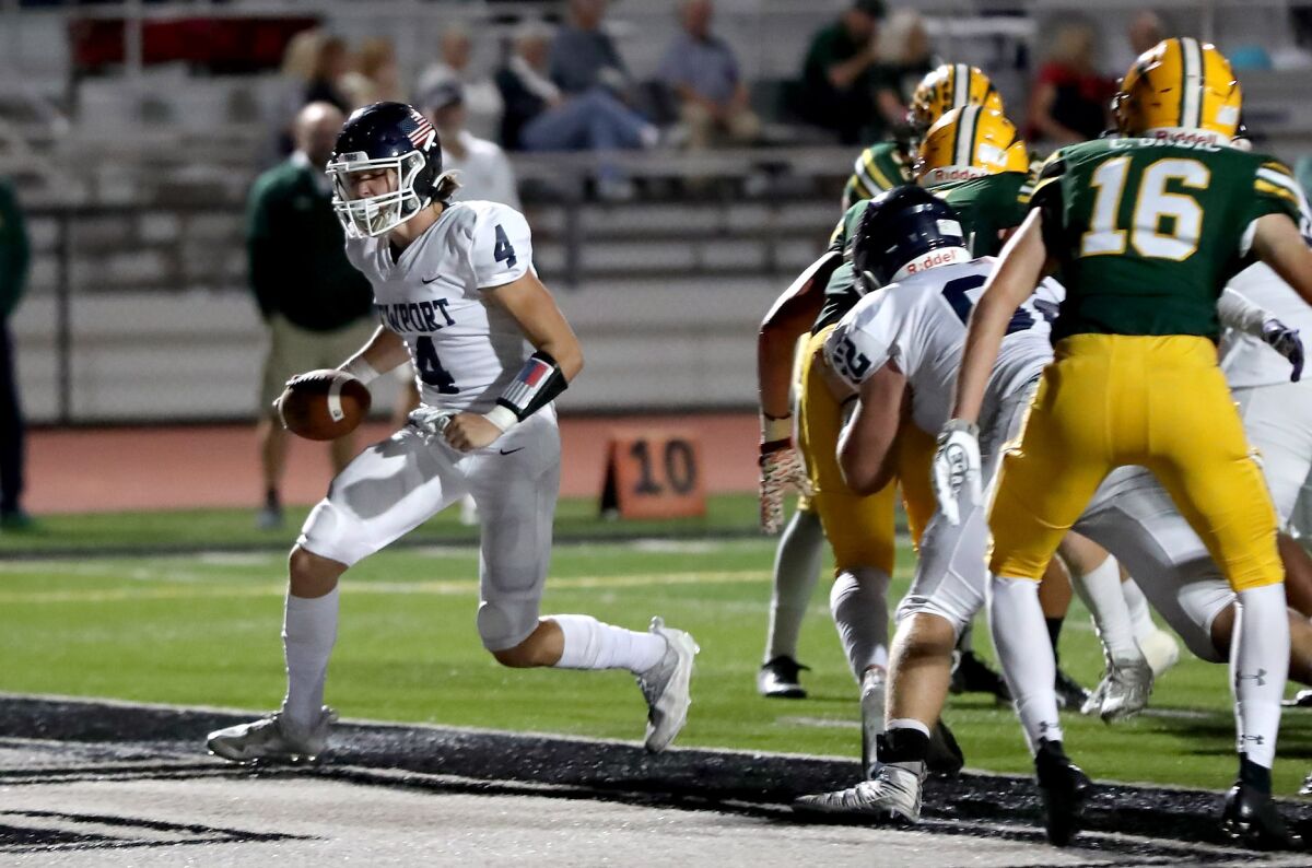 Newport Harbor's Carson de Avila (4) walks into the end zone for a touchdown a game against Edison in 2021.