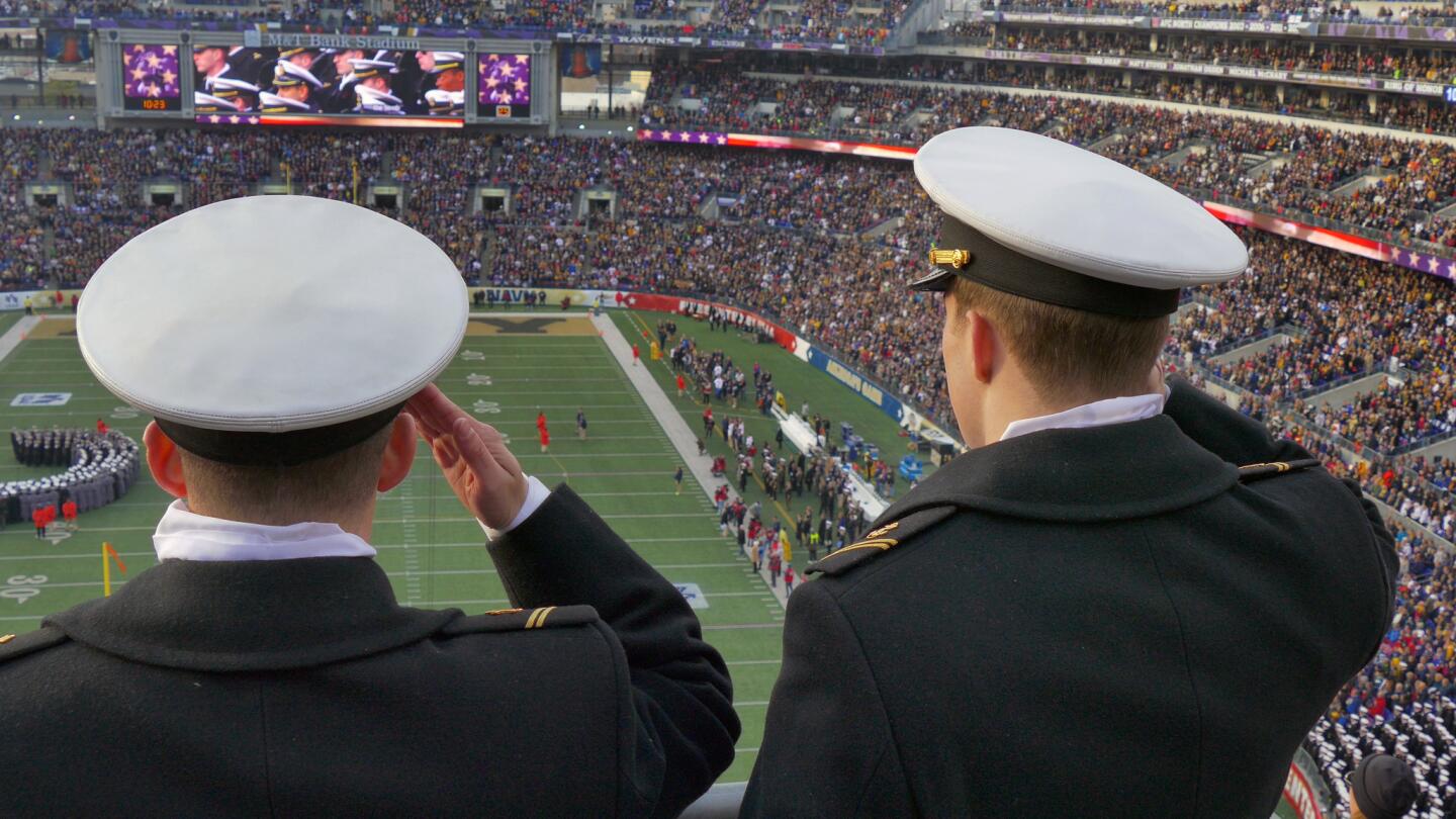 Midshipmen salute as the national anthem plays before the game at M&T Bank Stadium.