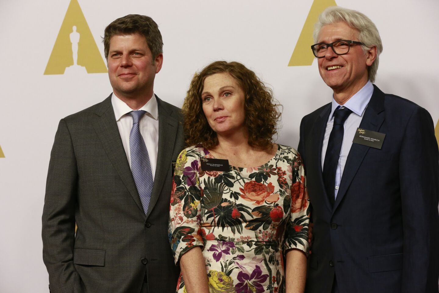 Adam Stockhausen, left, Rena DeAngelo, and Bernhard Henrick arrive for the 88th annual Academy Awards luncheon at the Beverly Hilton Hotel.