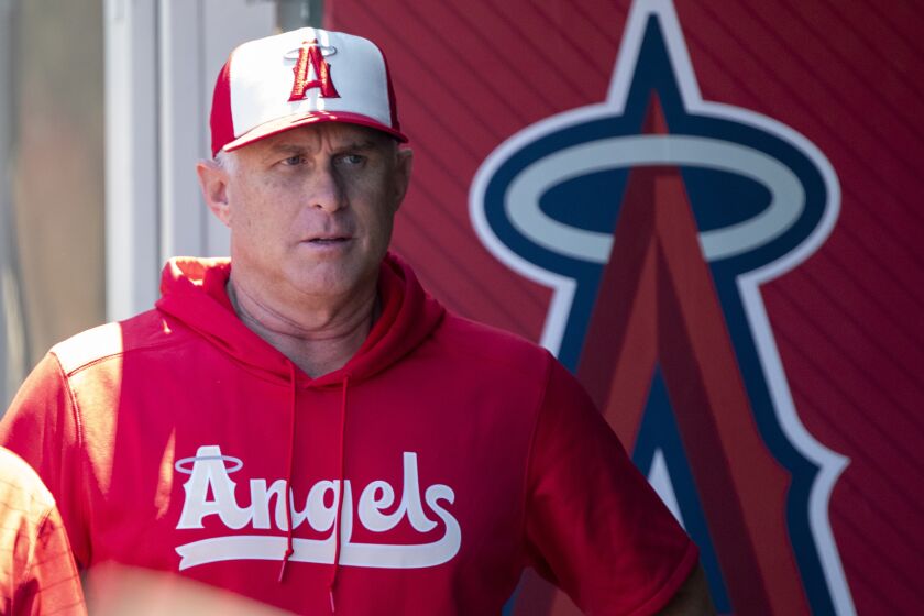 Los Angeles Angels interim manager Phil Nevin walks in the dugout to speak to the media before a baseball game against the New York Mets in Anaheim, Calif., Sunday, June 12, 2022. (AP Photo/Alex Gallardo)