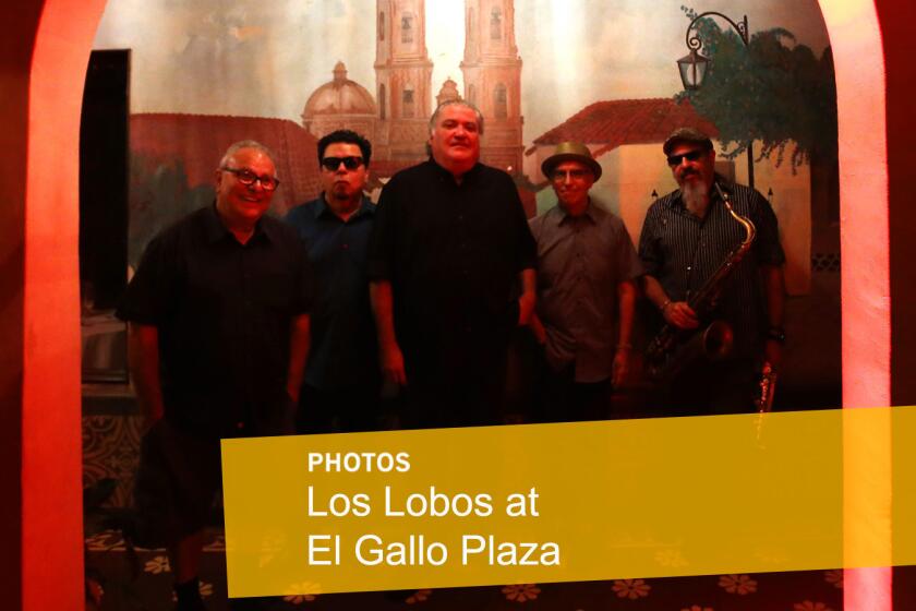 Los Lobos members Conrad Lozano, left, Cesar Rosas, David Hidalgo, Louie Perez and Steve Berlin before performing an intimate concert for family and friends to celebrate their new album, "Gates of Gold," at El Gallo Plaza in East Los Angeles on Sept. 29.