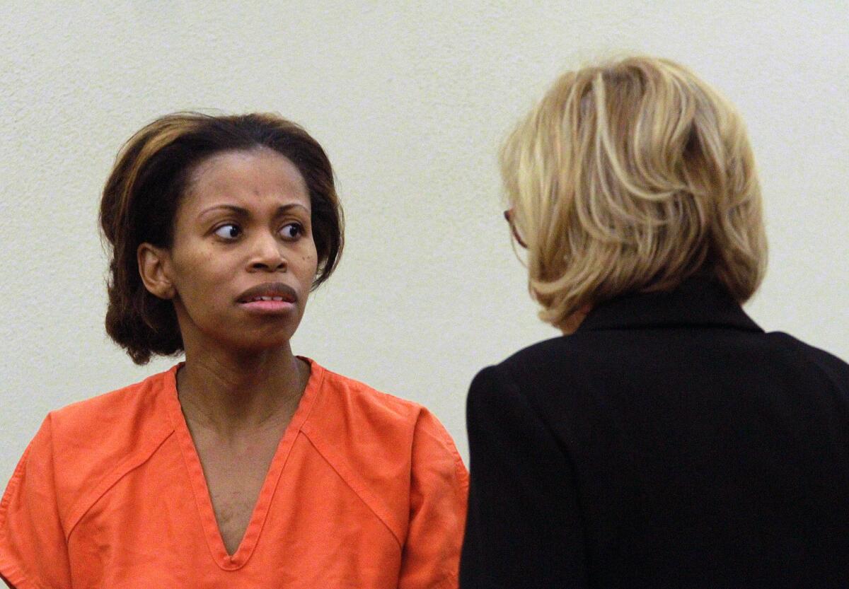 Ebony Wilkerson, left, looks at her assistant public defender Nora Hall during her first appearance before a Volusia County Court judge on Saturday in Daytona Beach, Fla. Wilkerson is charged with three counts of attempted murder after driving her minivan into the ocean with her three children onboard, her bond was set at $1.2 million.