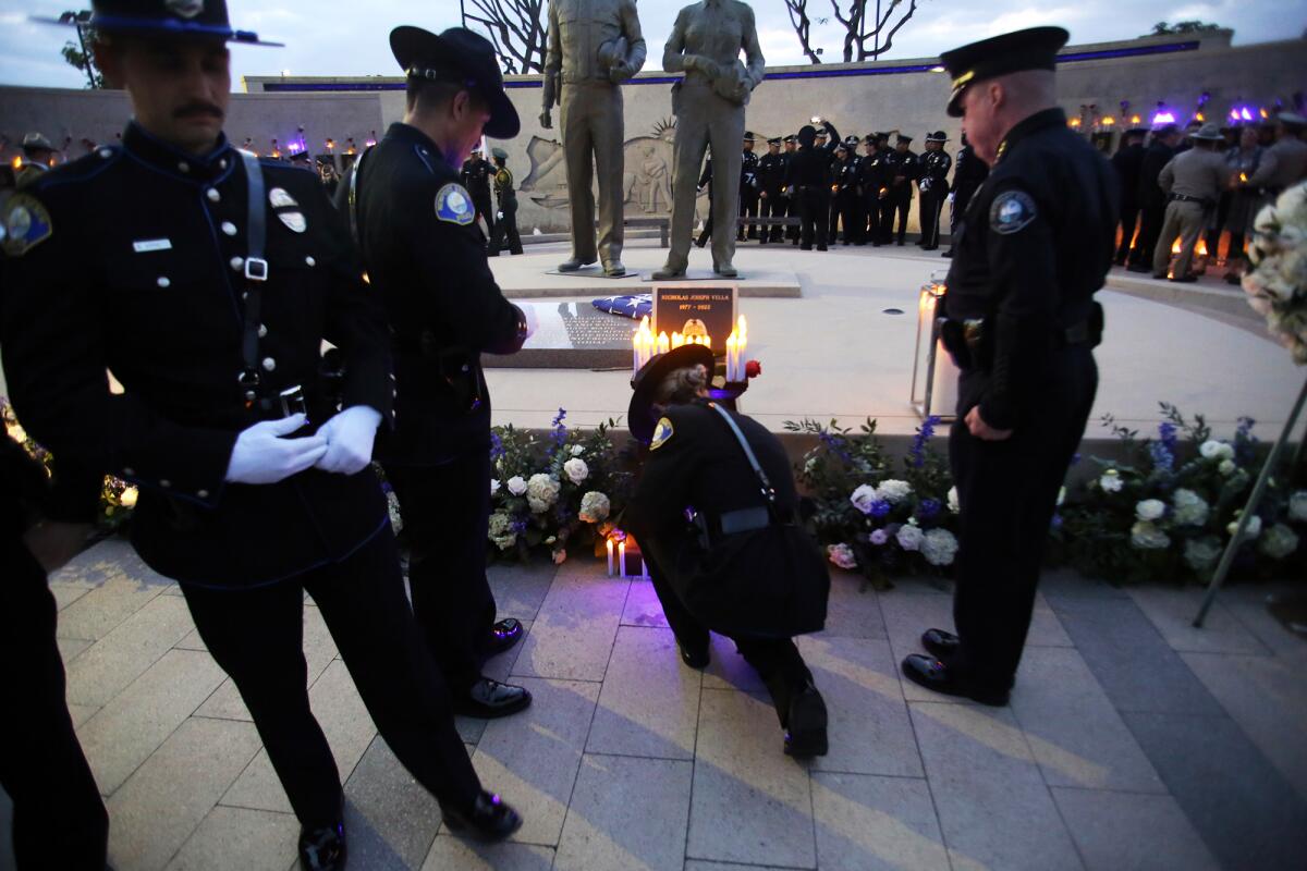 Officers from the Newport Beach Police Department pay their respects during Thursday's ceremony.
