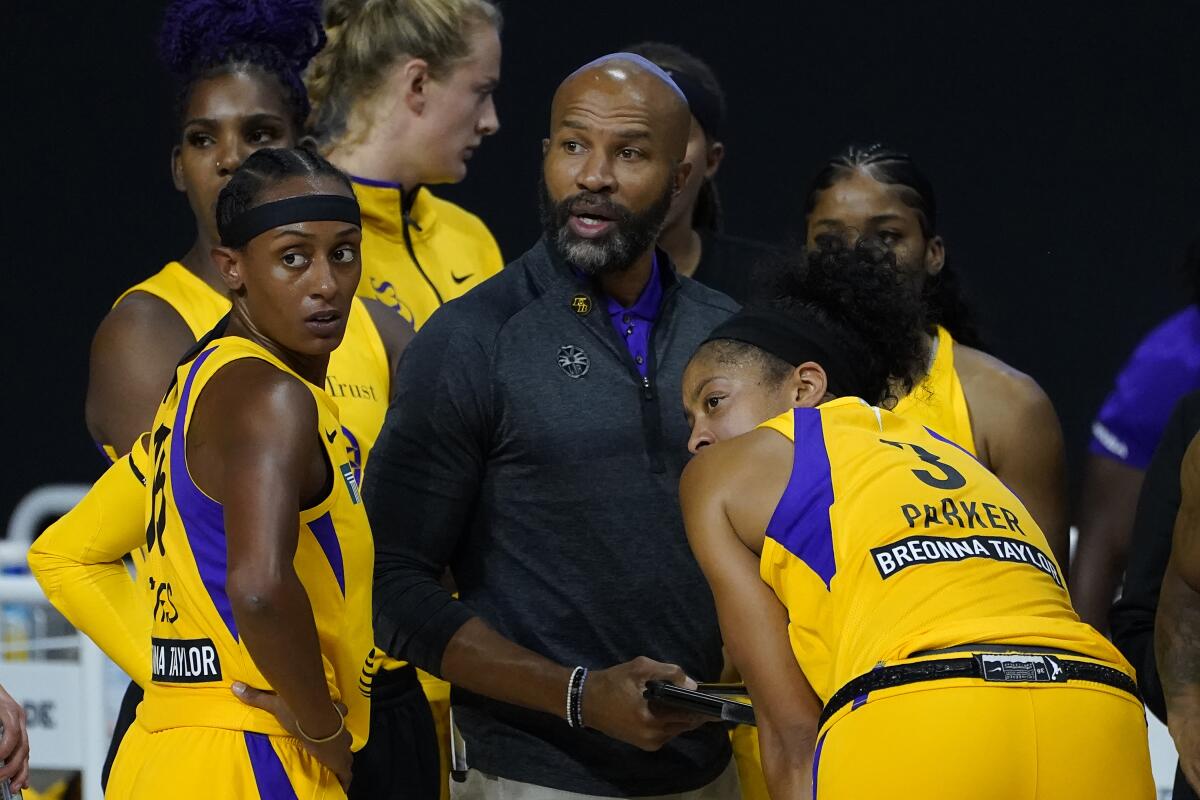 Sparks head coach Derek Fisher talks to guard Brittney Sykes (15) and forward Candace Parker during a timeout.