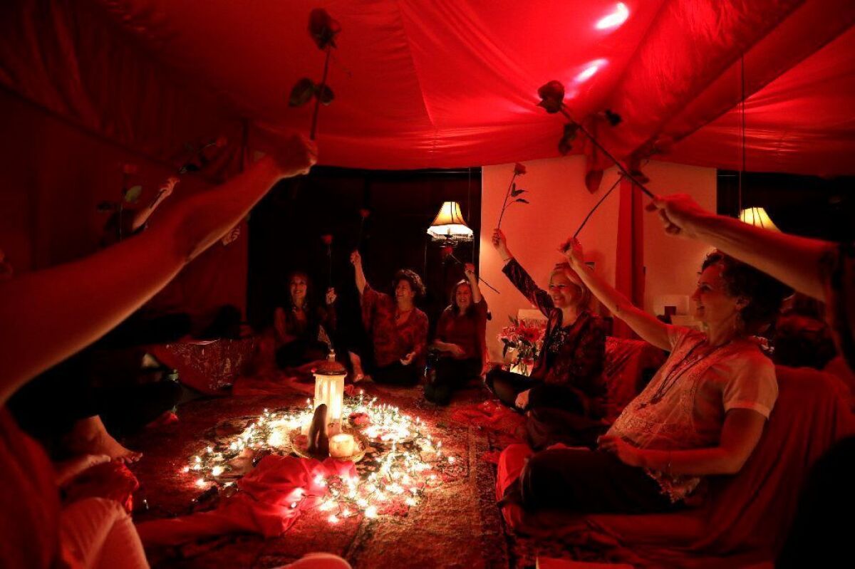 At "Red Tent" gatherings, women inspired by the bestselling novel by Anita Diamant meet at the start of the monthly lunar cycle to connect with their bodies and each other. This gathering was held in March in a Mar Vista condo, its walls swathed in scarlet fabric.