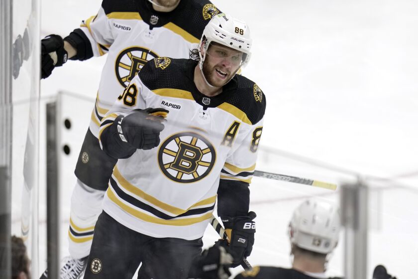 Boston Bruins' David Pastrnak (88) returns to the bench after scoring during the second period of an NHL hockey game against the Pittsburgh Penguins in Pittsburgh, Saturday, April 1, 2023. The Bruins won 4-3. (AP Photo/Gene J. Puskar)