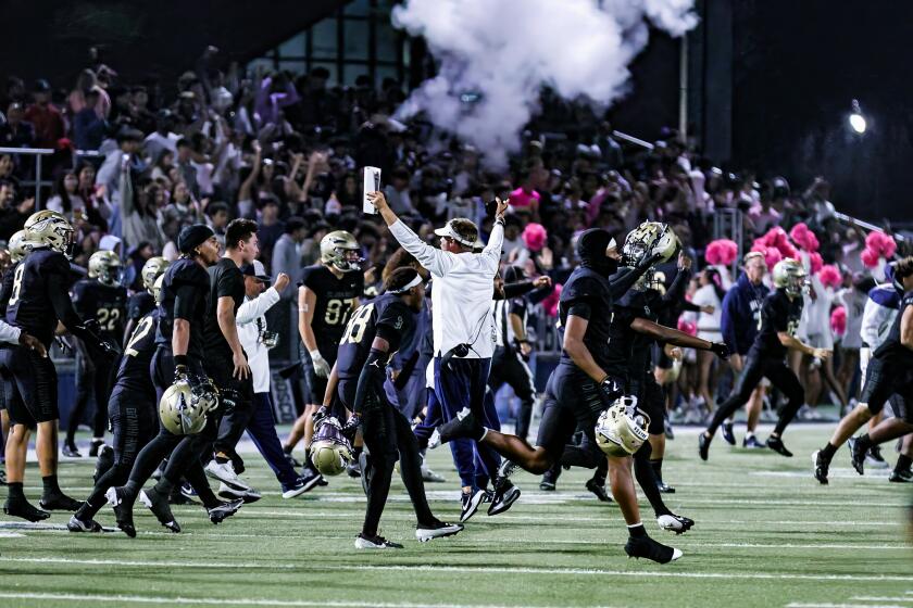 St. John Bosco launches victory celebration after stopping Orange Lutheran on game's final play for 28-24 win.