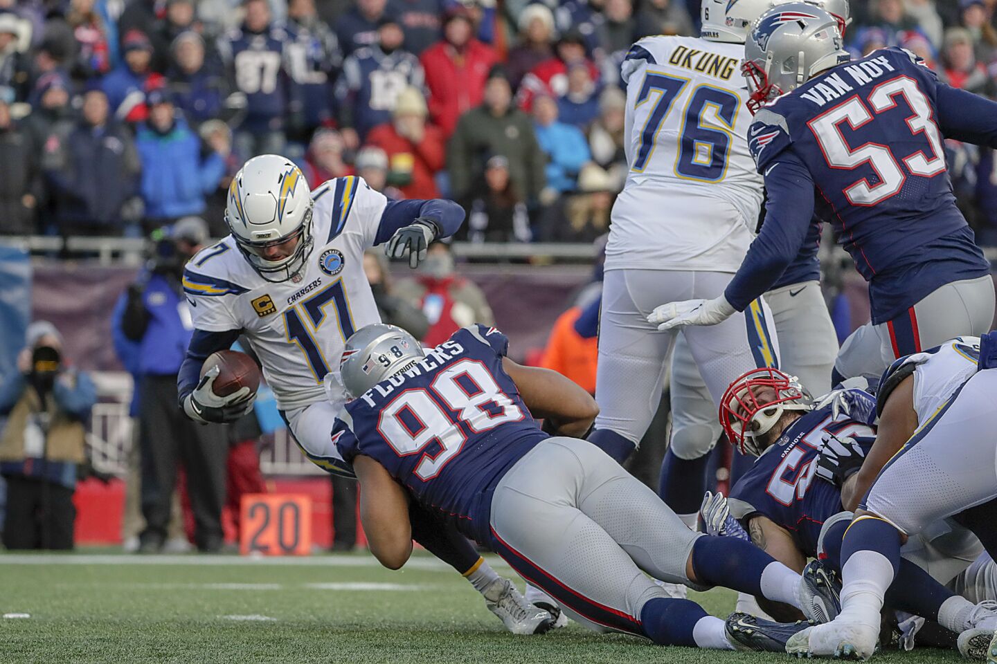 Chargers quarterback Philip Rivers is sacked by New England Patriots defensive lineman Trey Flowers late in the second quarter in the NFL AFC Divisional Playoff at Gillette Stadium on Sunday.