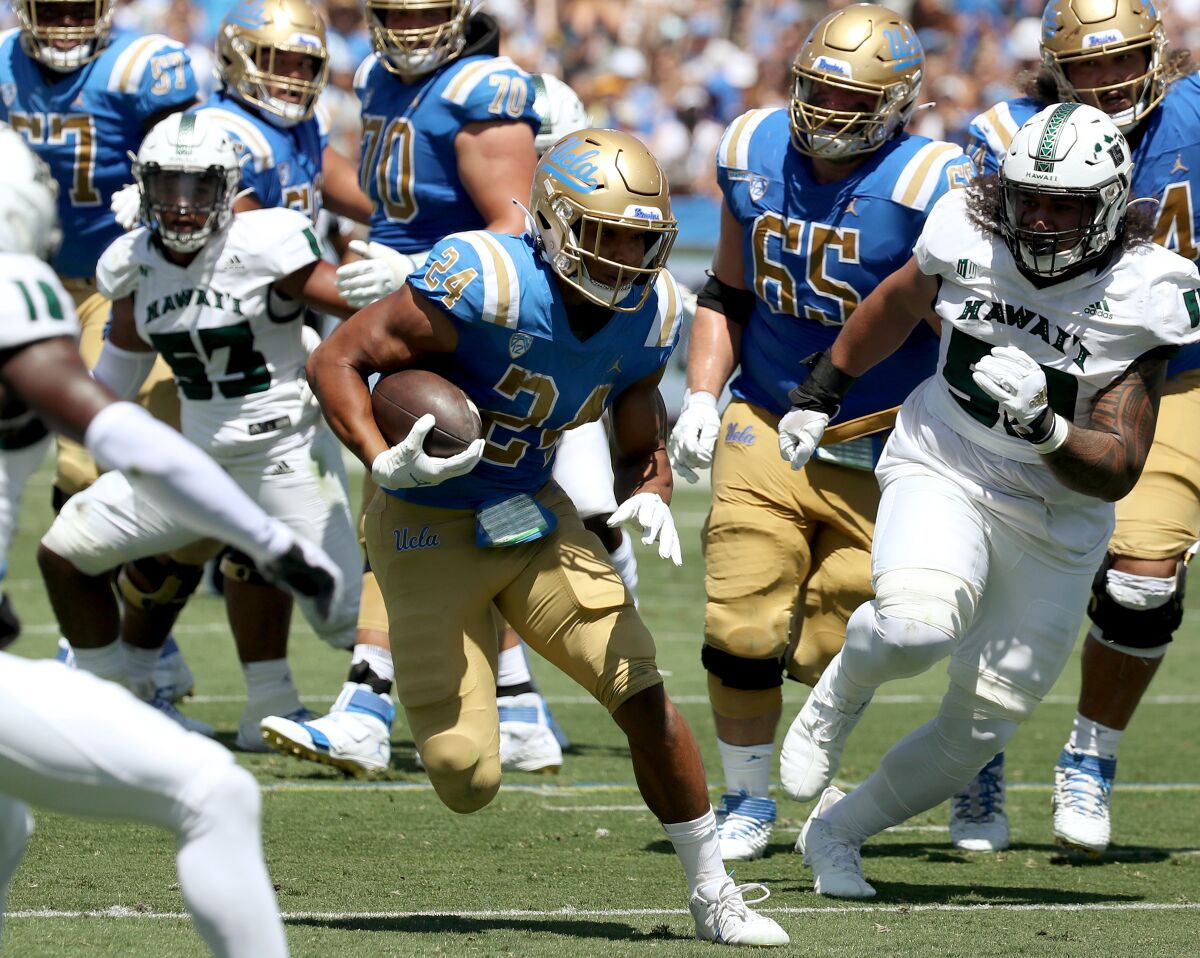 UCLA running back Zach Charbonnet breaks free for a touchdown against Hawaii in the second quarter Saturday.
