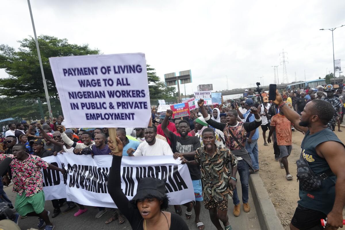 People hold signs and march in the street.