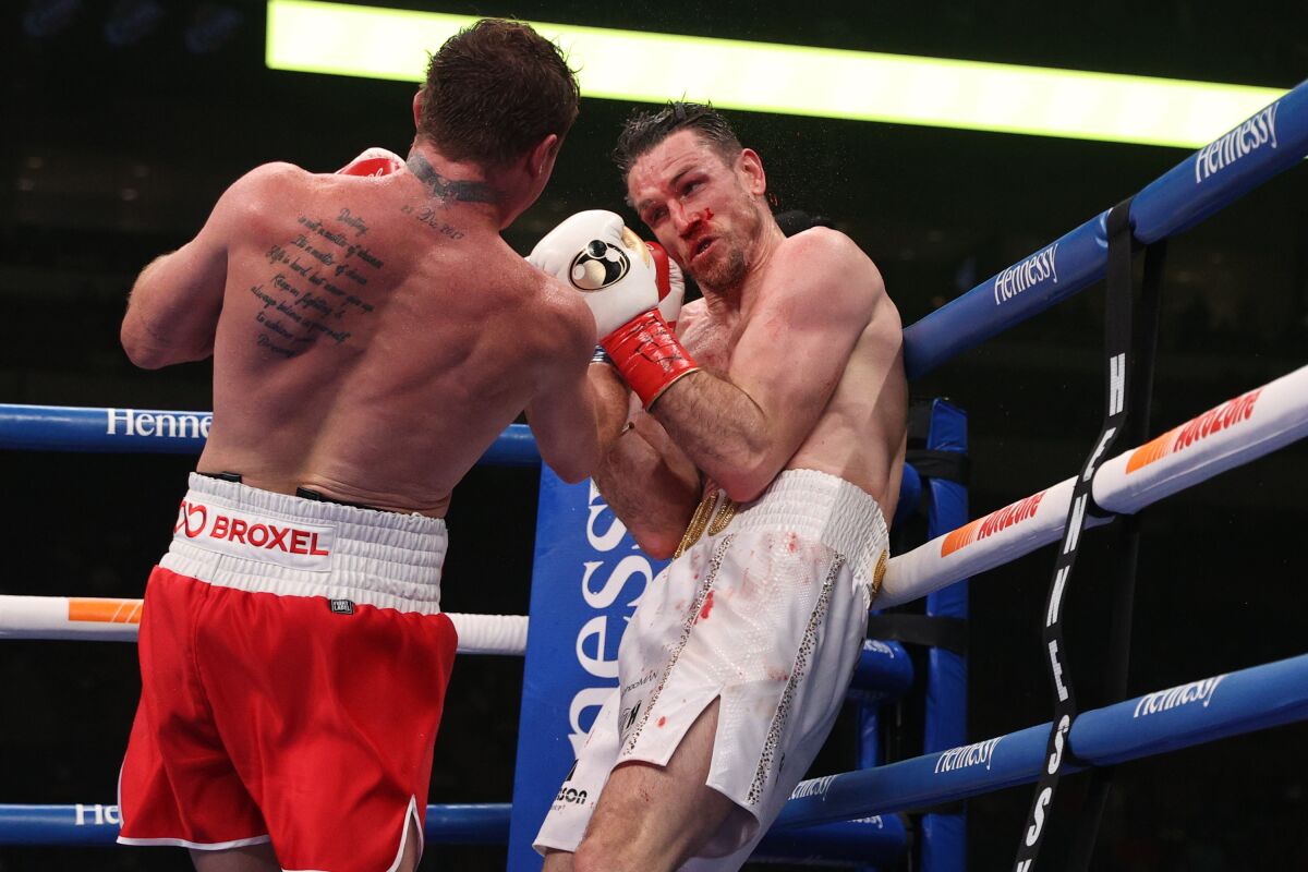 Canelo Alvarez, left, punches Callum Smith during their title fight at the Alamodome in San Antonio on Saturday.