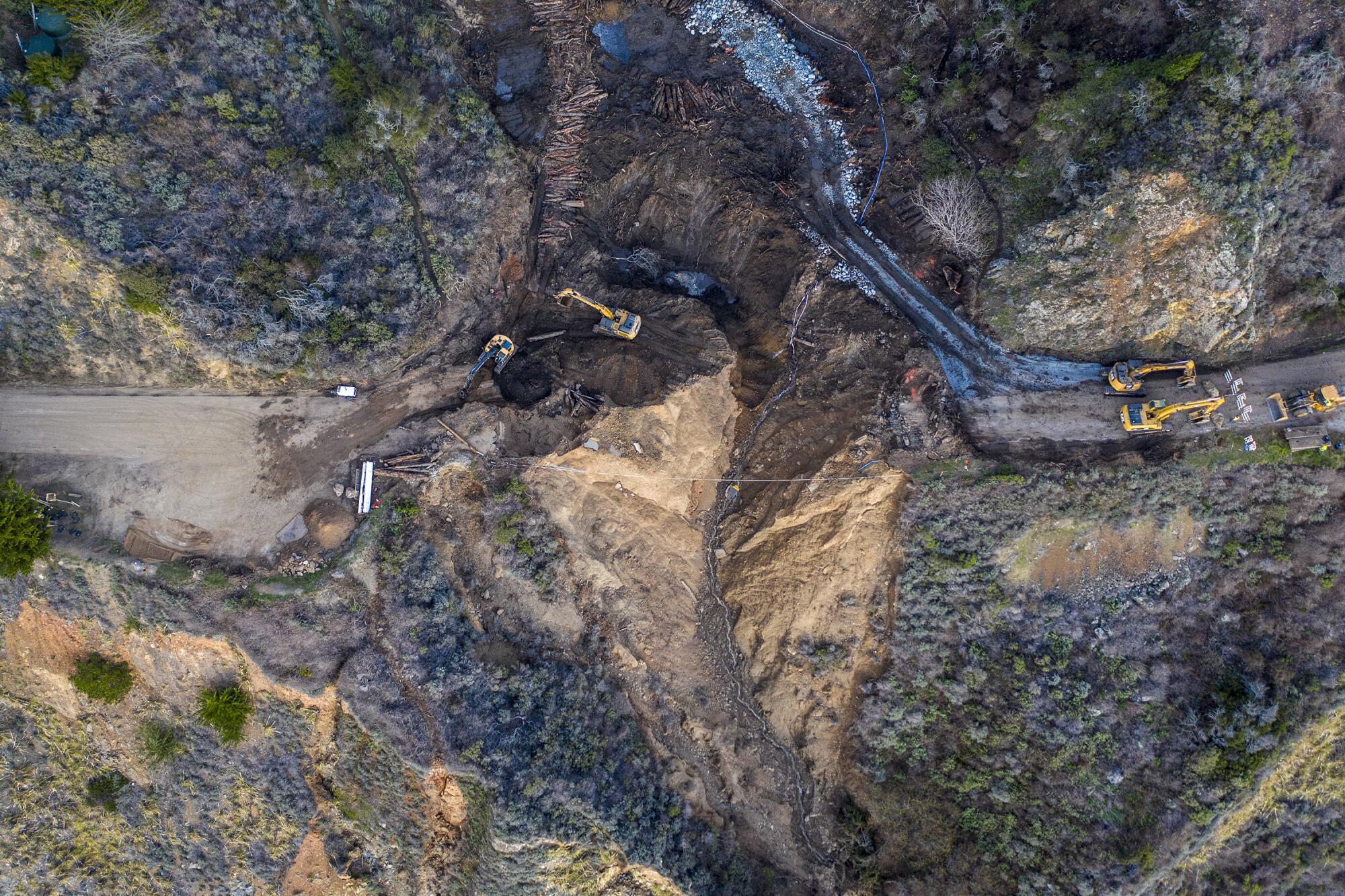 A broken coastal road seen from above.