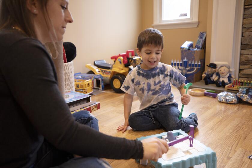 Ilana Diener plays with her son, Hudson, 3, at home in Commack, N.Y. on Nov. 30, 2021, before an appointment for a Moderna COVID-19 vaccine trial. On Wednesday, March 23, 2022, Moderna said its COVID-19 vaccine works in babies, toddlers and preschoolers, and if regulators agree it could mean a chance to finally start vaccinating the littlest kids by summer. (AP Photo/Emma H. Tobin)