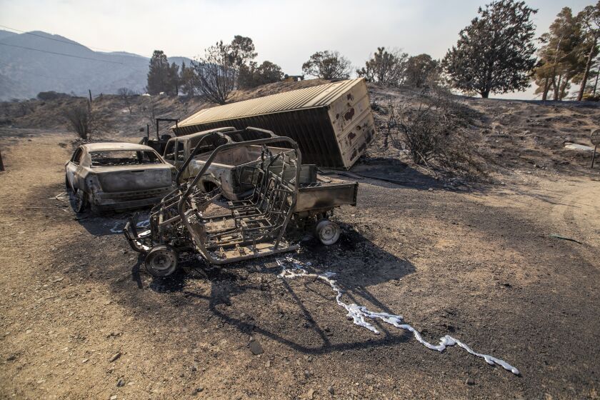 JUNIPER HILLS, CA - SEPTEMBER 20: The remains of burned automobiles as the Bobcat fire continues to burn in the Angeles National Forest in Juniper Hills Sunday, Sept. 20, 2020. Some houses and structures in the Juniper Hills area were lost in the Bobcat fire but most were saved. (Allen J. Schaben / Los Angeles Times)