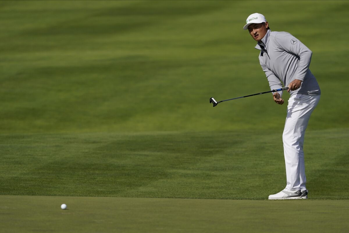 Li Haotong of China, watches his putt on the 10th hole during the second round of the PGA Championship golf tournament at TPC Harding Park Friday, Aug. 7, 2020, in San Francisco. (AP Photo/Charlie Riedel)