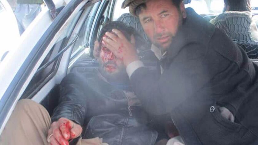 An injured man is taken to a hospital after an explosion in northwest Pakistan.
