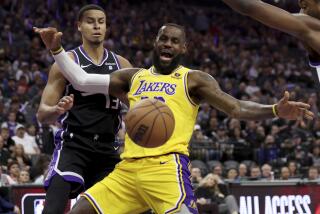 Los Angeles Lakers forward LeBron James, right, is defend by Sacramento Kings forward Keegan Murray during the first half of an NBA basketball game in Sacramento, Calif, Wednesday, March 13, 2024. (AP Photo/Jed Jacobsohn)