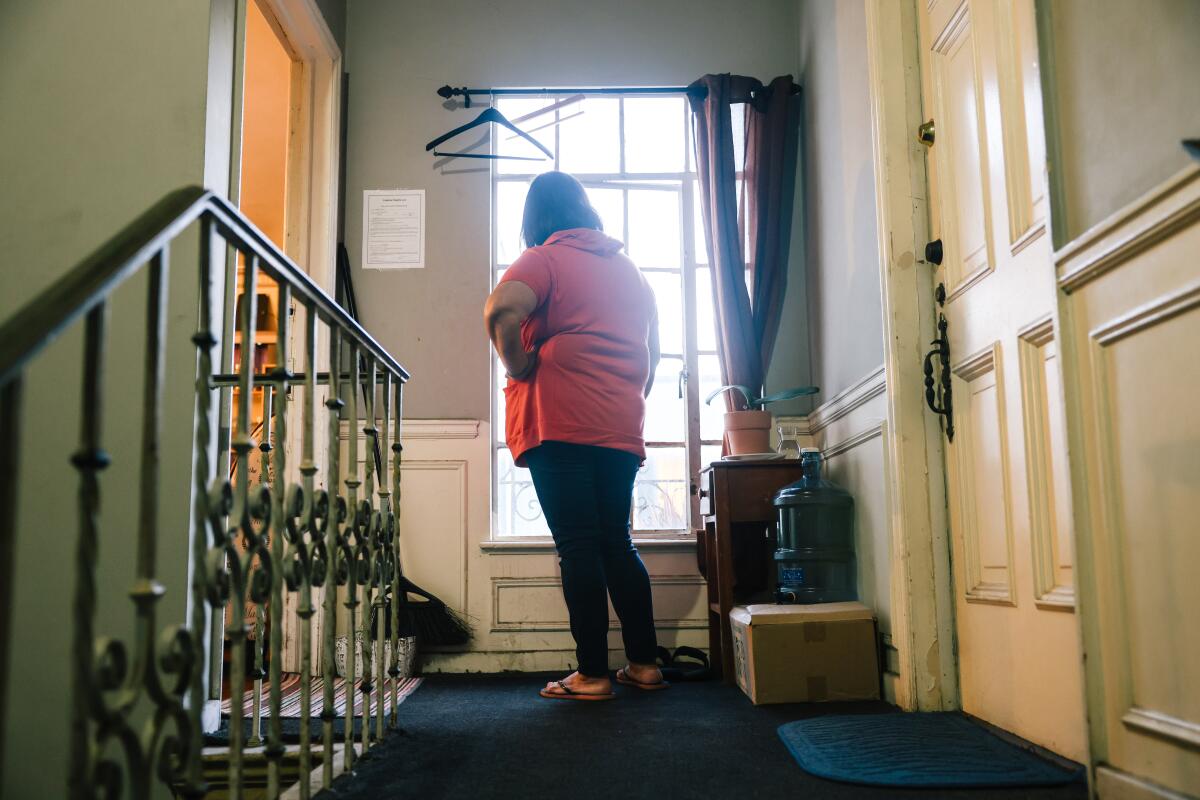 Jovita Cuevas stands outside her apartment in Koreatown. 