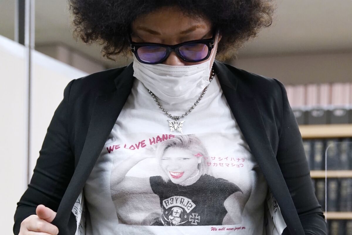 Kyoko Kimura wears a T-shirt with an image of her daughter and wrestler Hana at a press club in Tokyo on May 19, 2021. Japan’s parliament approved tougher penalties for criminal defamation Monday, June 13, 2022 in a move prompted by the bullied wrestler's suicide and that is raising free speech concerns. Parliamentary deliberations on toughening the defamation law began in January after Hana Kimura took her own life at 22. (Shohei Miyano/Kyodo News via AP)