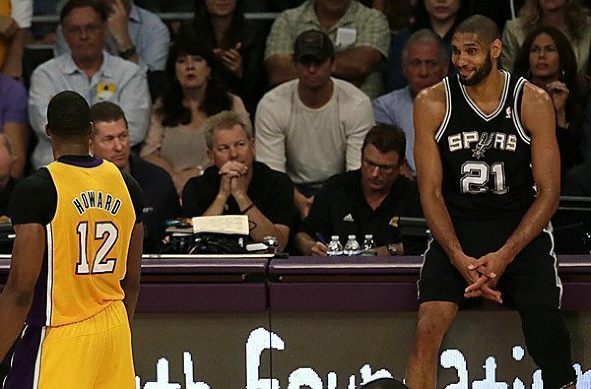 Spurs forward Tim Duncan gives the Lakers' Dwight Howard a grin as Howard leaves the court in frustration after being called for a technical foul in the second half of Game 3 at Staples Center on Friday night.