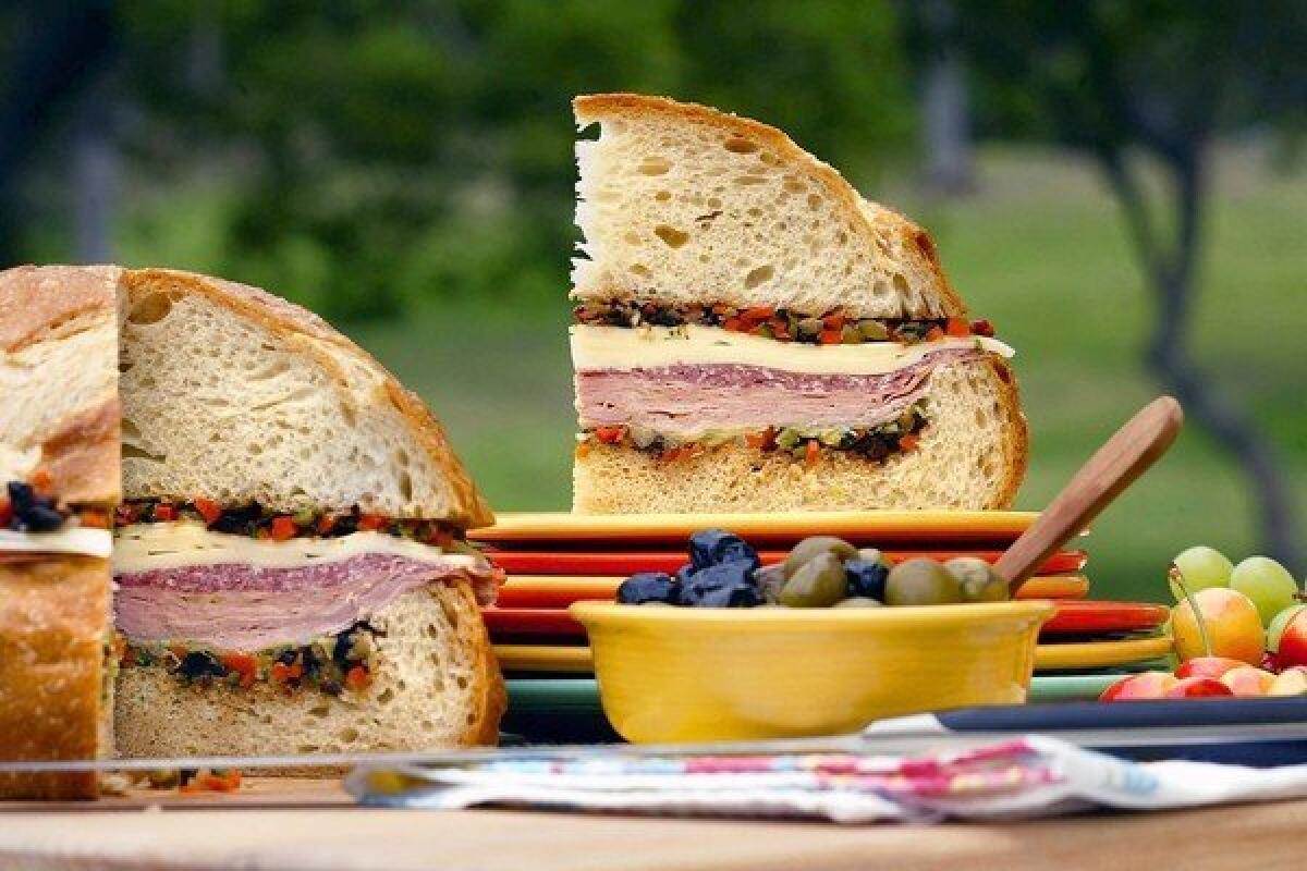 Packed with deli meat and pickled vegetables, the muffuletta is a portable meal-in-one that's ideal for sharing.