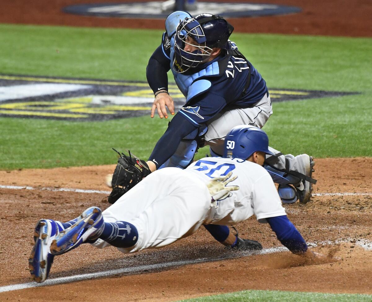 Dodgers Mookie Betts beats the tag of Rays catcher Mike Zunino to sore