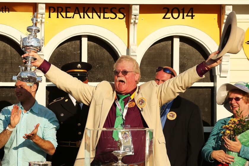 California Chrome co-owner Steve Coburn celebrates on the podium in the Winner's Circle after his horse won the Preakness Stakes on Saturday.