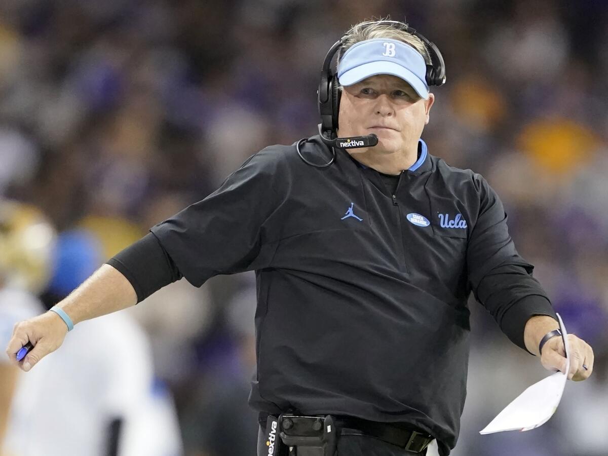 UCLA coach Chip Kelly stands on the sideline during a game.