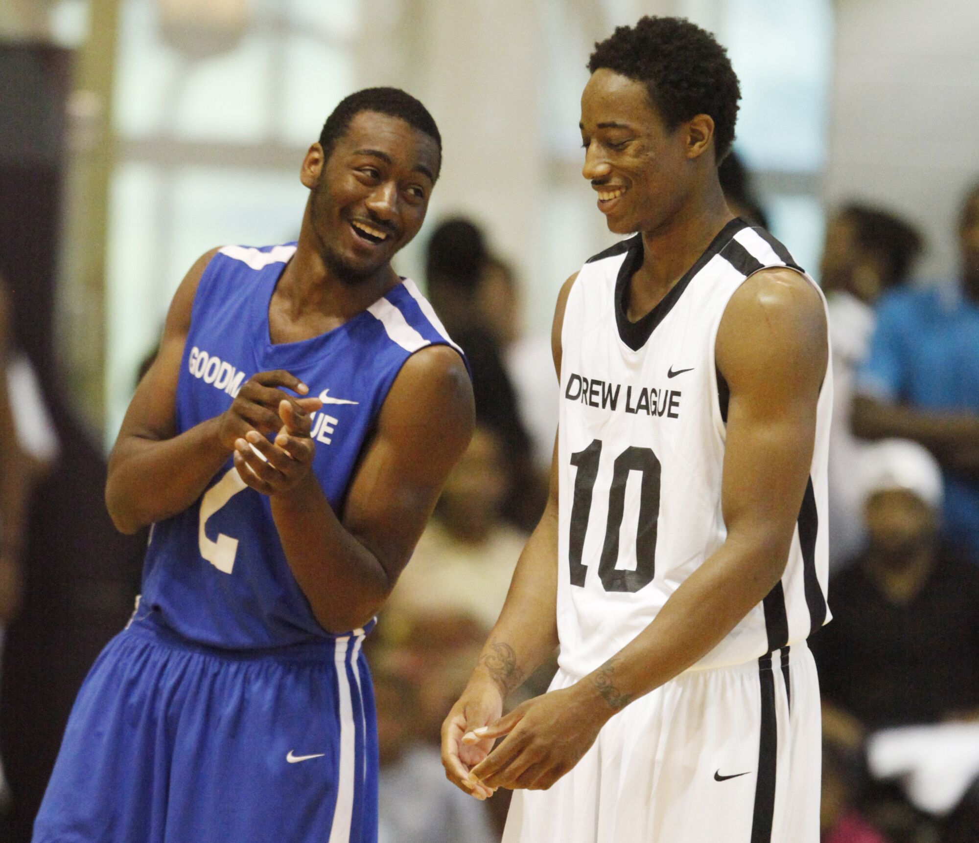 John Wall chats with DeMar DeRozan during an exhibition game between Goodman League and Drew League teams in 2011.